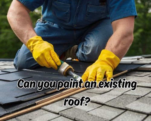 Roofer spreading paint evenly on roof.